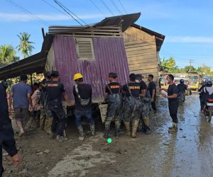 Bahu Membahu, Brimob Pindahkan Rumah Terseret Banjir yang Melintang di Jalan Nasional Tamiang–Langsa